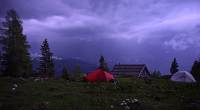 Wir fliehen unter eine Veranda einer Almhütte, ein Gewitter zieht direkt über uns, eigentlich ist es Stockdunkel aber durch die Blitze ist das Foto so hell